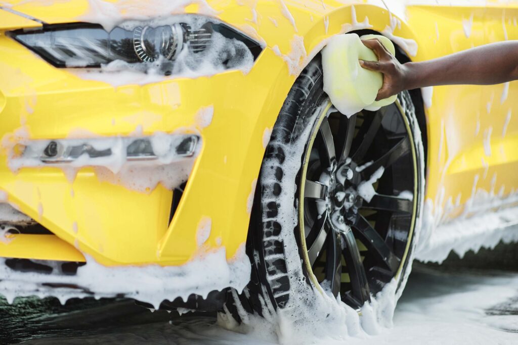 cleaning-of-modern-rims-of-luxury-yellow-car-at-se-SDA8U2E.jpg